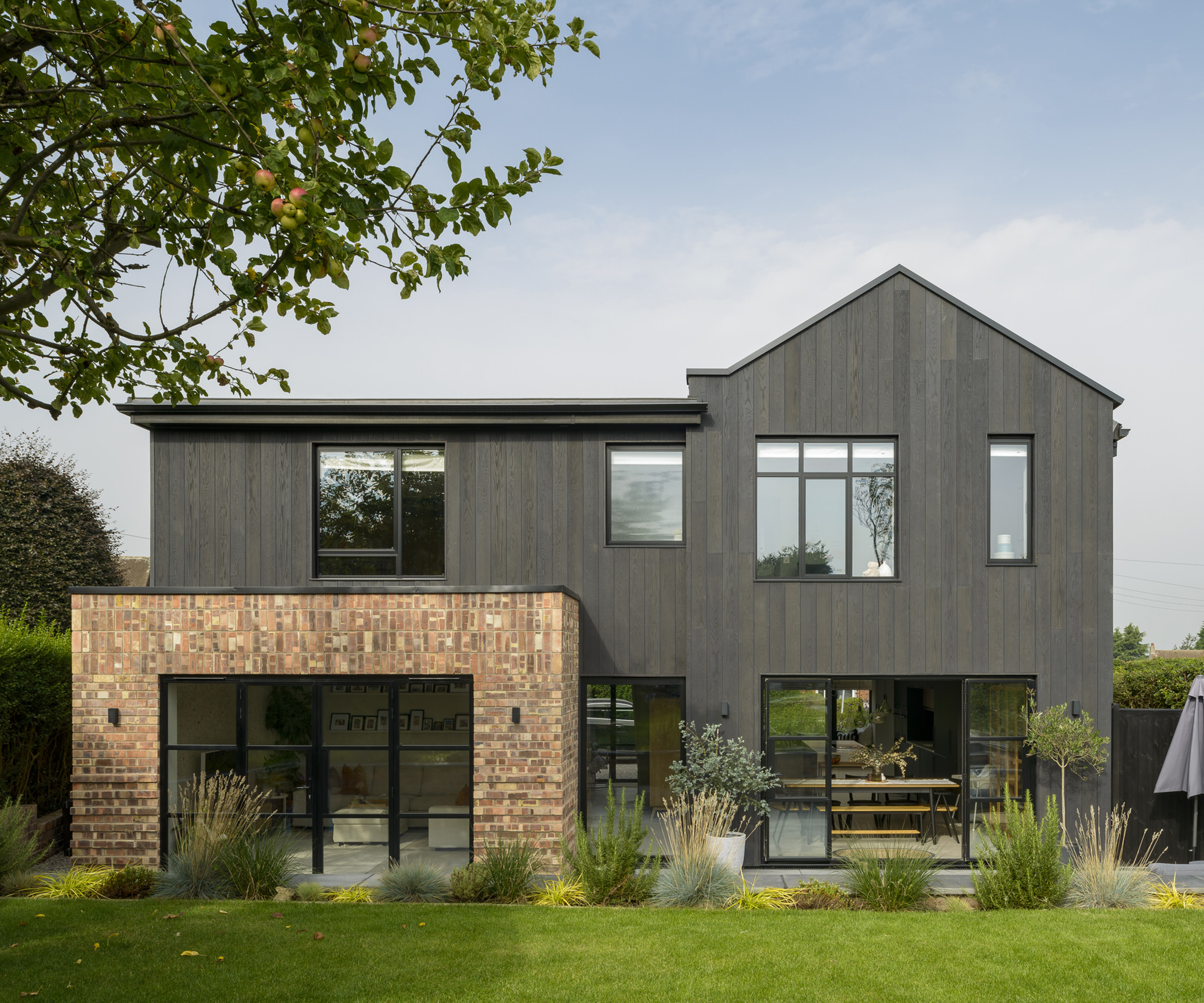 The front of a newly renovated two storey home clad in black timber