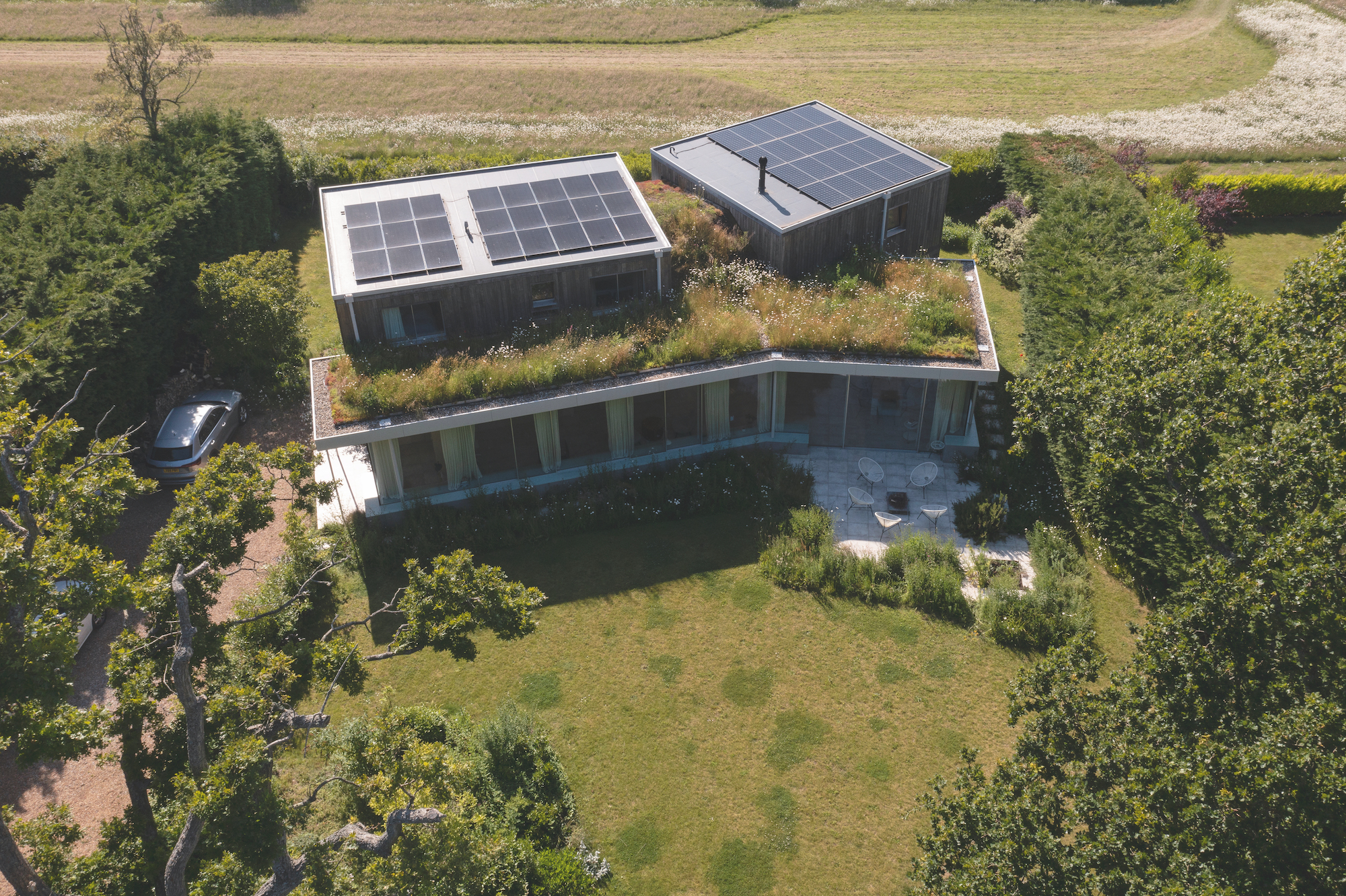 self build house with solar panels and green roof