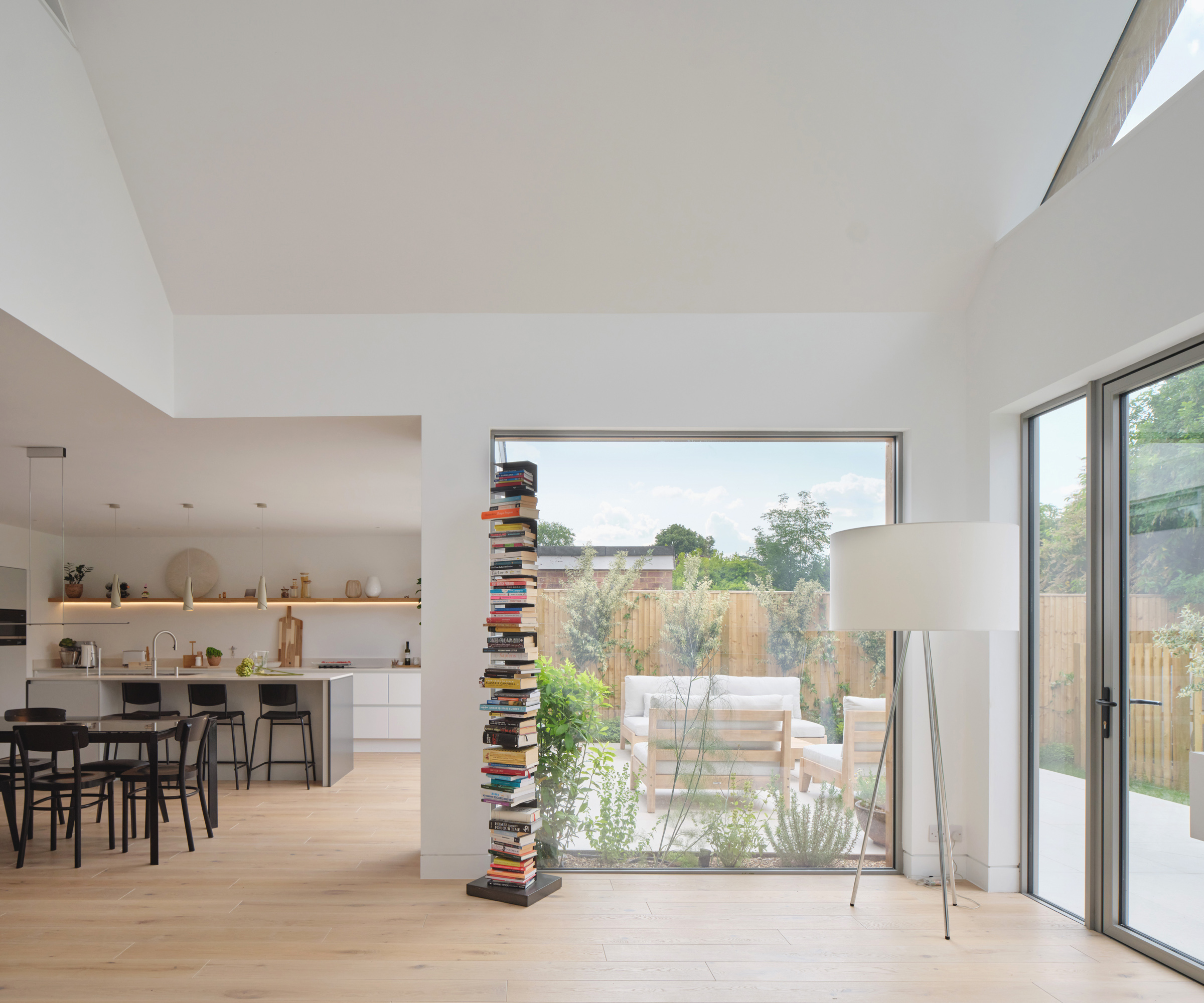 Contemporary bungalow conversion with floor to ceiling windows and a vaulted ceiling