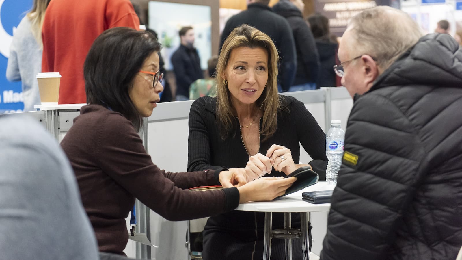 A couple talking to an expert at the Advice Centre at the Homebuilding &amp; Renovating Show